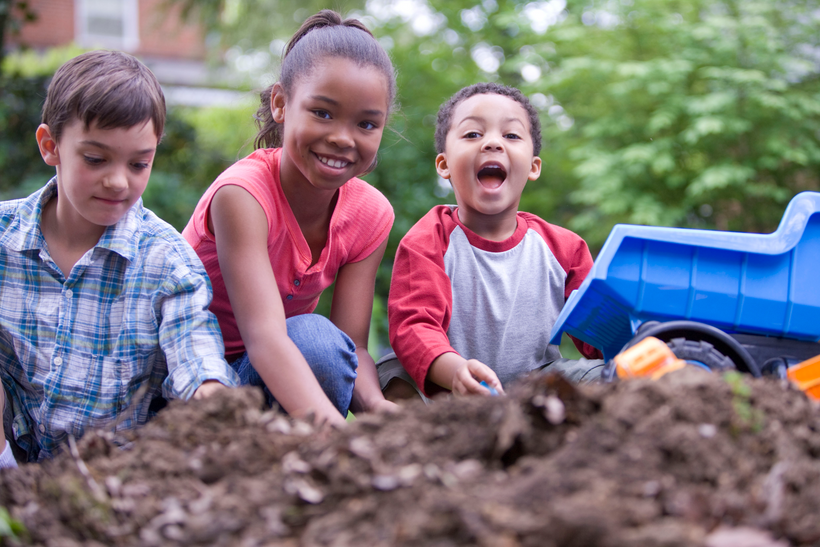 Three children playing outside in a backyard dirt pile, enjoying the fresh air, physical activity, and interacting as friends.. Courtesy of the Public Health Image Library, Centers for Disease Control and Prevention.